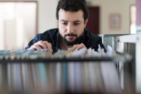 Man looking in a documentation file drawer Stock Photos
