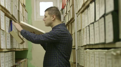 Man looking documents in the archive Stock Footage 59665532