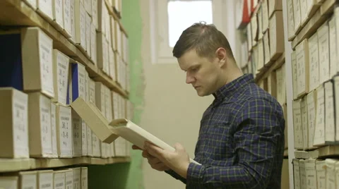 Man looking documents in the archive Stock Footage 59665682