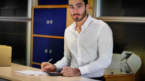 Man looking at documents at office counter Stock Photos