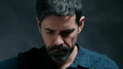 Man looking down and playing guitar Stock Footage 130792143