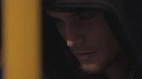 Man Looking Down with Black Hood Hiding from Someone Video stock 150089009