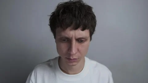 Man looking down feeling overwhelmed with stress Stock Footage 323437620