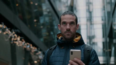Man looking down at phone in the city Stock Footage 130970939