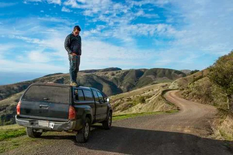 Man looking down from top of pick up truck, Big Sur, California, USA Stock Photos