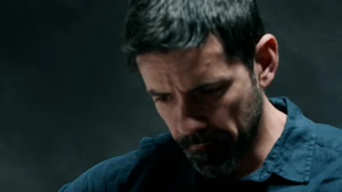 Man looking down while playing guitar Stock Footage 130791290