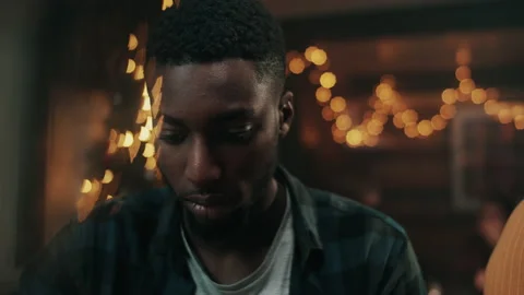 Man looking down while siting at a bar Stock Footage 132015808