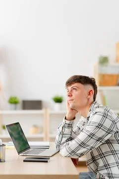 Man looking up dreaming with thoughtful expression working from home Stock Photos