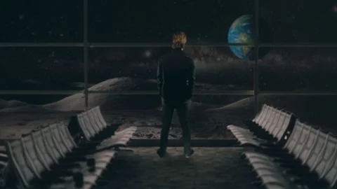 Man Looking at Earth Planet Inside Moon Base Zoom In Stock Footage 164376780