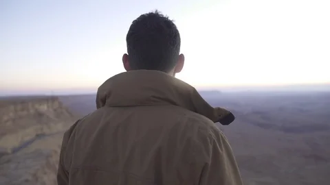 Man looking at the epic horizon of the desert Stock Footage 73079836