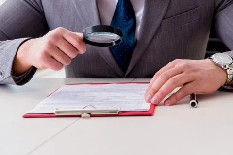 Man looking for errors and mistakes in report 스톡 사진