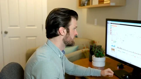 Man looking at finance chart on computer cheering, finished work project or Видео 152889680