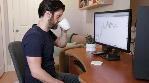Man looking at finance chart on computer, day trader, investing from home Stock Footage 153497481