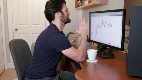 Man looking at finance chart on computer stressed out, praying and wishing for Stock Footage 153497857