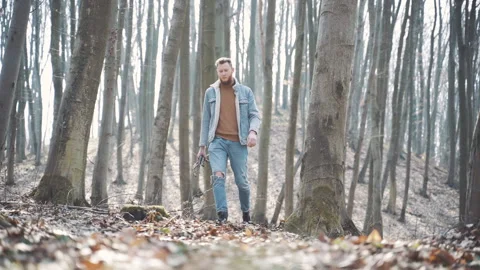 A man looking for firewood in the forest to make a fire Stock Footage 153030990