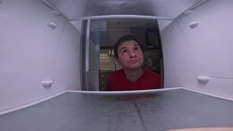 Man looking for food disappointed by empty fridge Stock Footage 287124361