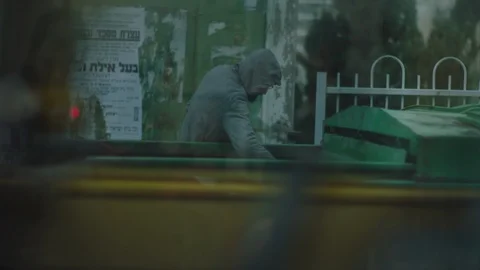 Man looking for food in the garbage Stock Footage 104526472