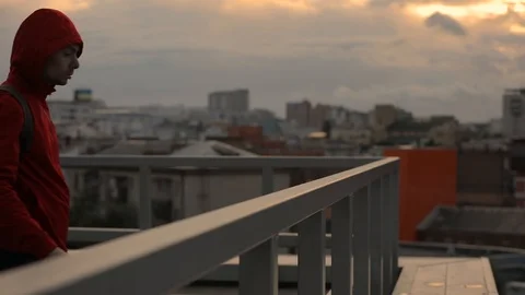 Man looking forward to the cityscape and thinking in cold autumn overcast day Stock Footage 95558357