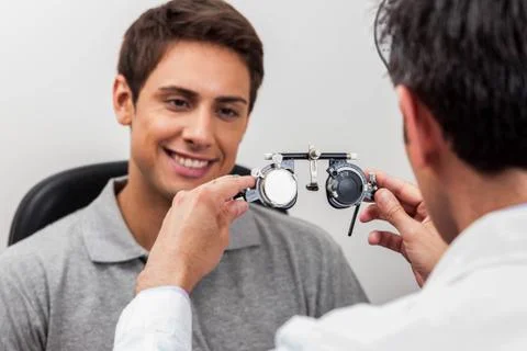 Man looking at the glasses 스톡 사진