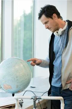 Man looking at globe Stock Photos