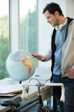 Man looking at globe Stock Photos