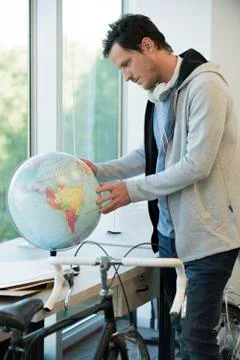 Man looking at globe Stock Photos