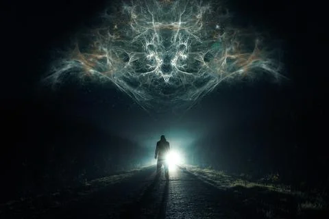 A man looking at a glowing alien floating in the sky. On a spooky road Stock Photos