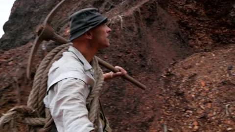 A man is looking for gold in the mountains. The treasure hunter Stock Footage 147275704