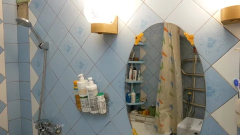 Man looking at himself in the bathroom mirror Video stock 127575668