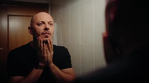 Man Looking at Himself in the Mirror Stock Footage 297991395