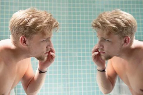 Man looking at himself in mirror Stock Photos