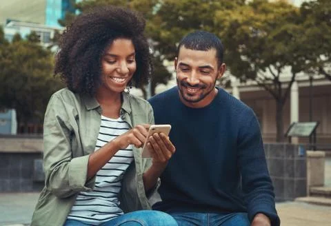 Man looking at his girlfriend using mobile phone Stock Photos