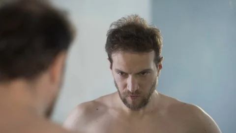 Man looking at his mirror reflection with hatred and shame, feeling guilty Stock Footage