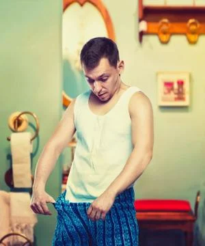 Man looking at his penis, problems with small size Stock Photos