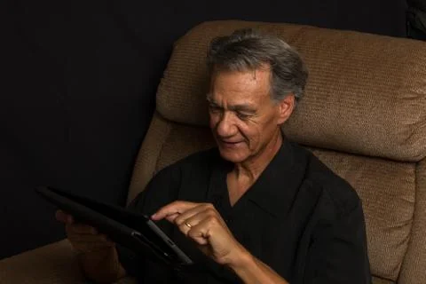 Man Looking at his Smart Table Stock Photos