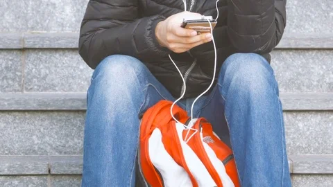 Man Looking at His Smartphone and Listening Music Video stock 73729462
