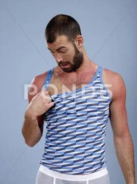 A man looking at his sunburned chest Stock Photos