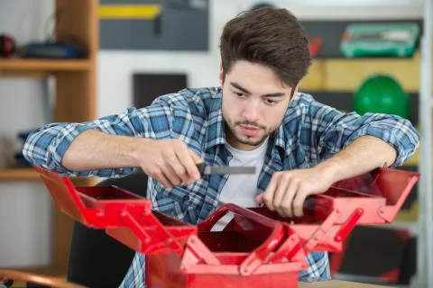 Man looking in his tool box Stock Photos