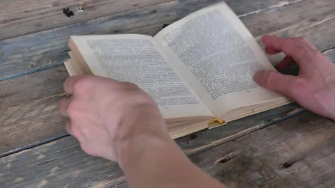 The man is looking for information in the book. Exam preparation Stock Footage 134621231