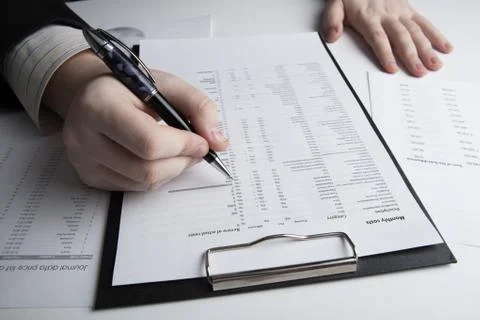 Man is looking for information in the in the budget figures Stock Photos