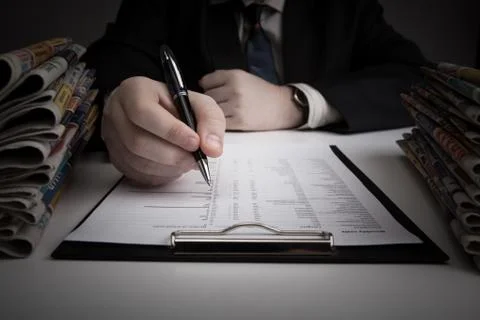 Man is looking for information in the in the budget figures Stock Photos