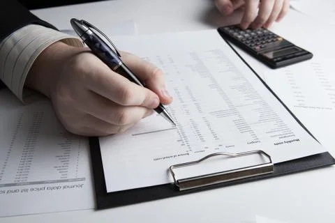 Man is looking for information in the in the budget figures Stock Photos