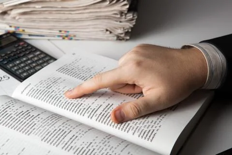 Man is looking for information in the dictionary Stock Photos