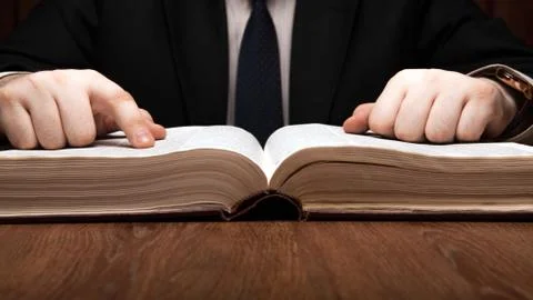 Man is looking for information in the dictionary Stock Photos