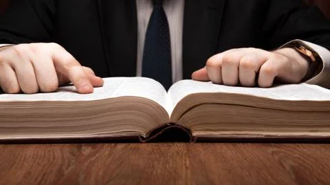 Man is looking for information in the dictionary Stock Photos