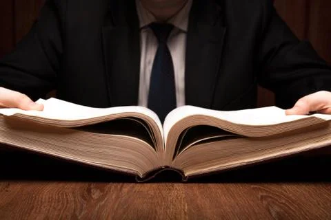 Man is looking for information in the dictionary Stock Photos