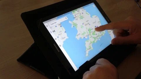 Man Looking At Map Of Great Britain On Tablet Computer 02 Stock Footage 99986897