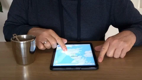Man Looking At Map Of Great Britain On Tablet Computer 04 Stock Footage 99987072