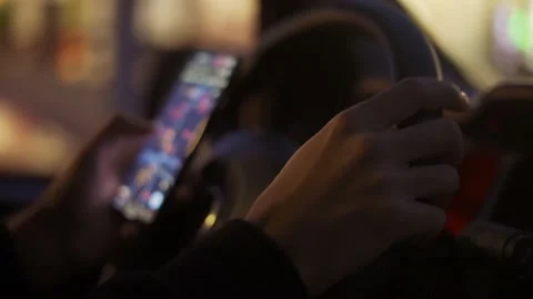 A man looking map on his mobile phone during driving at night Видео 170184543
