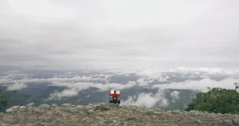 Man looking at map on mountain top aerial shot Stock Footage 89689763